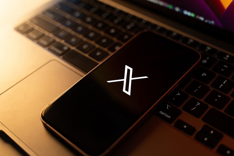 Handy mit Laptop und dem X für die Plattform X.