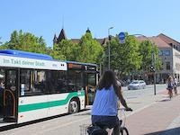 Henkestraße bus stop with bus, cyclist and pedestrians.