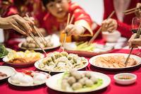 A man at a table with many plates of food.