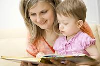 Woman looking at book with child