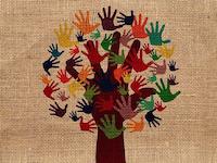 A tree with colorful hands on textile