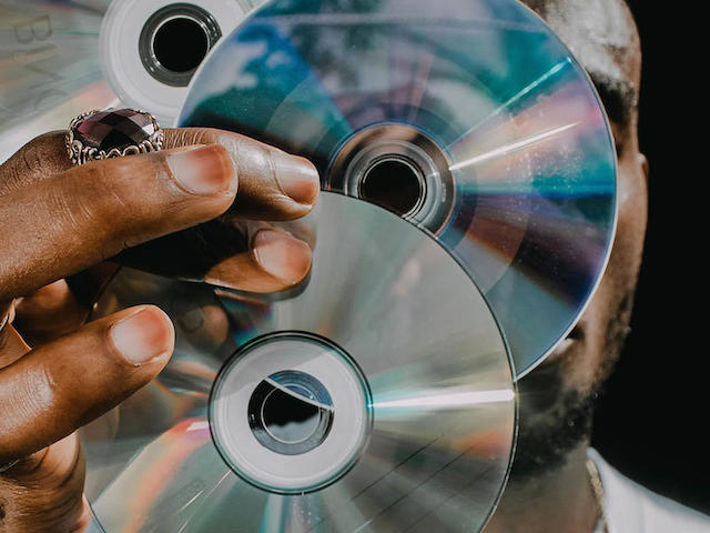 Man holding old CDs.