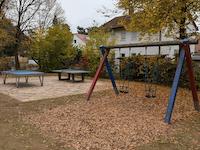 Two toddler swings and two table tennis tables