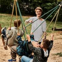 Caregiver with children playing.