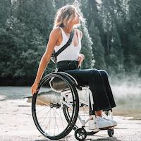 Woman sits in wheelchair.