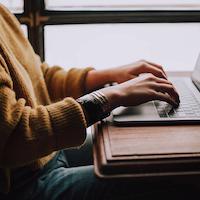 Woman sitting at laptop.