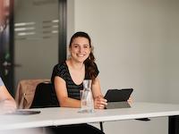 Employees with tablets at a meeting.