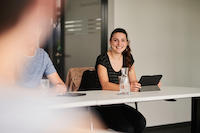 Woman smiling in meeting with tablet_thumbnail_main_page