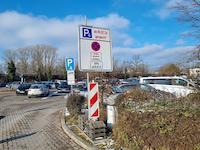 The large parking lot with sign